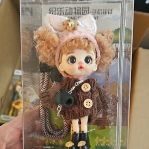 Curly-Haired Doll in Brown Knit Coat and Pink Ear Headband
